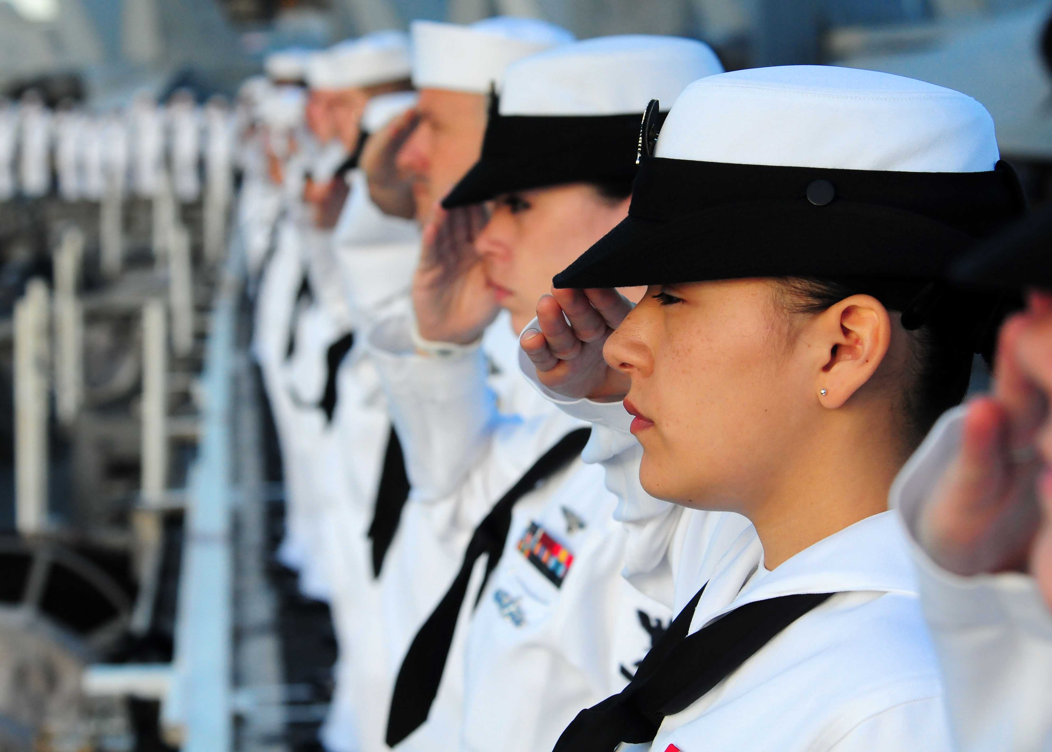 Sailors and Marines render honors as USS Ronald Reagan passes the USS Arizona Memorial.jpg