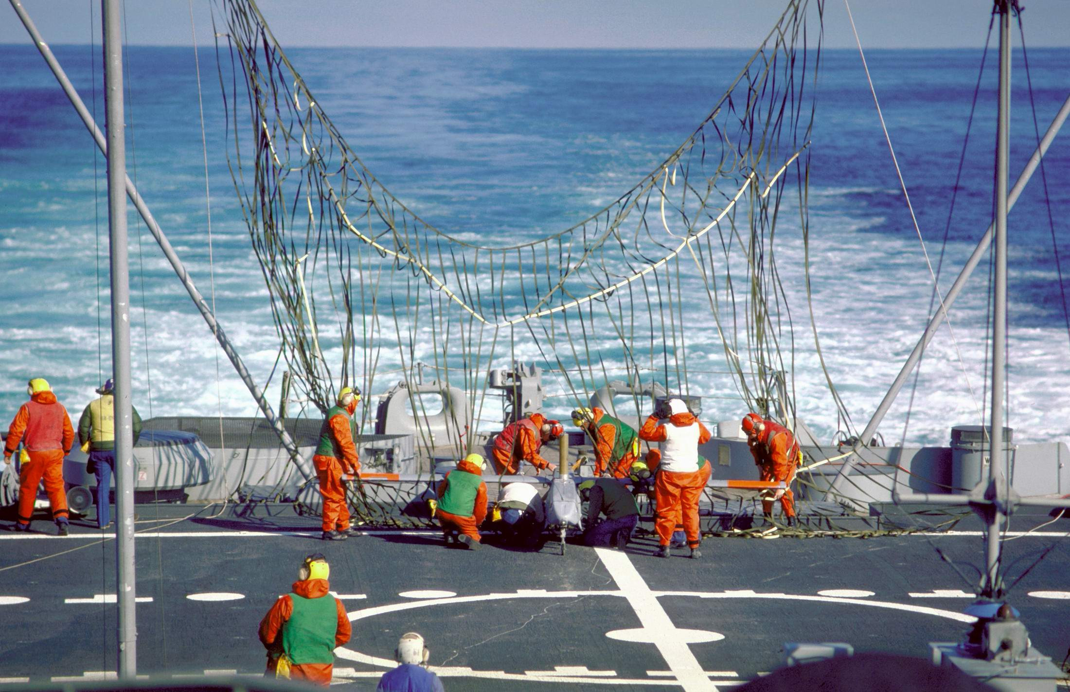 Crewmen disengage a Pioneer I remotely-piloted vehicle (RPV) from a recovery net erected on the stern of the battleship USS IOWA (BB-61).jpg