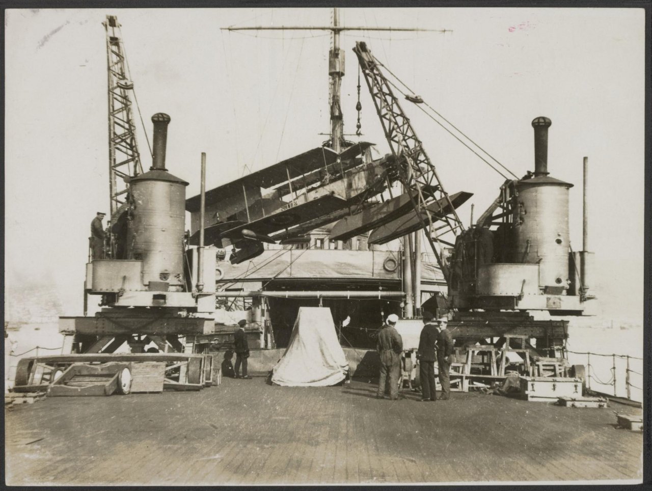Scene on board of a British seaplane ship. Bringing a seaplane out of the hold..jpg